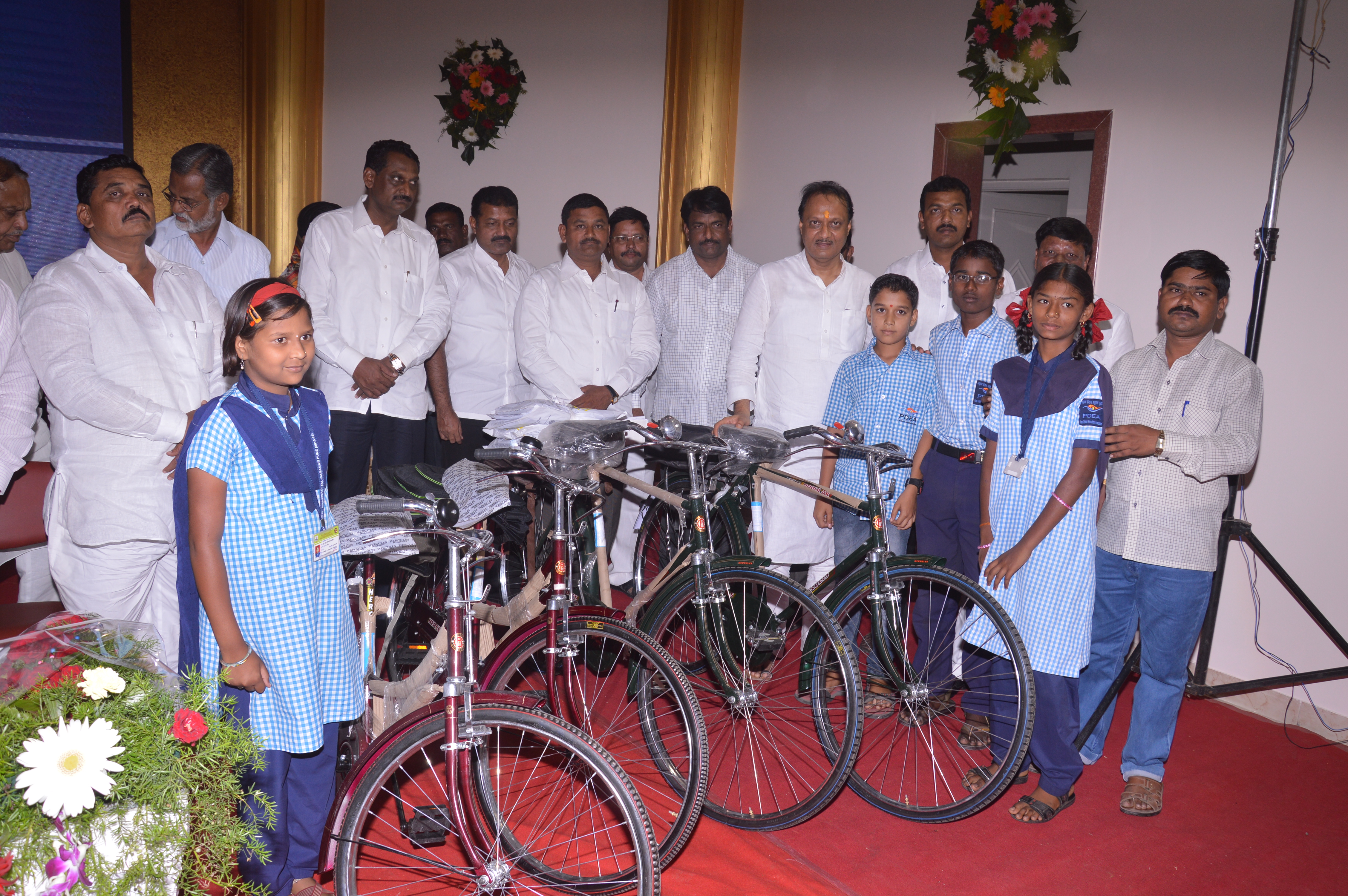 Distribution of educational material and bicycle to school students