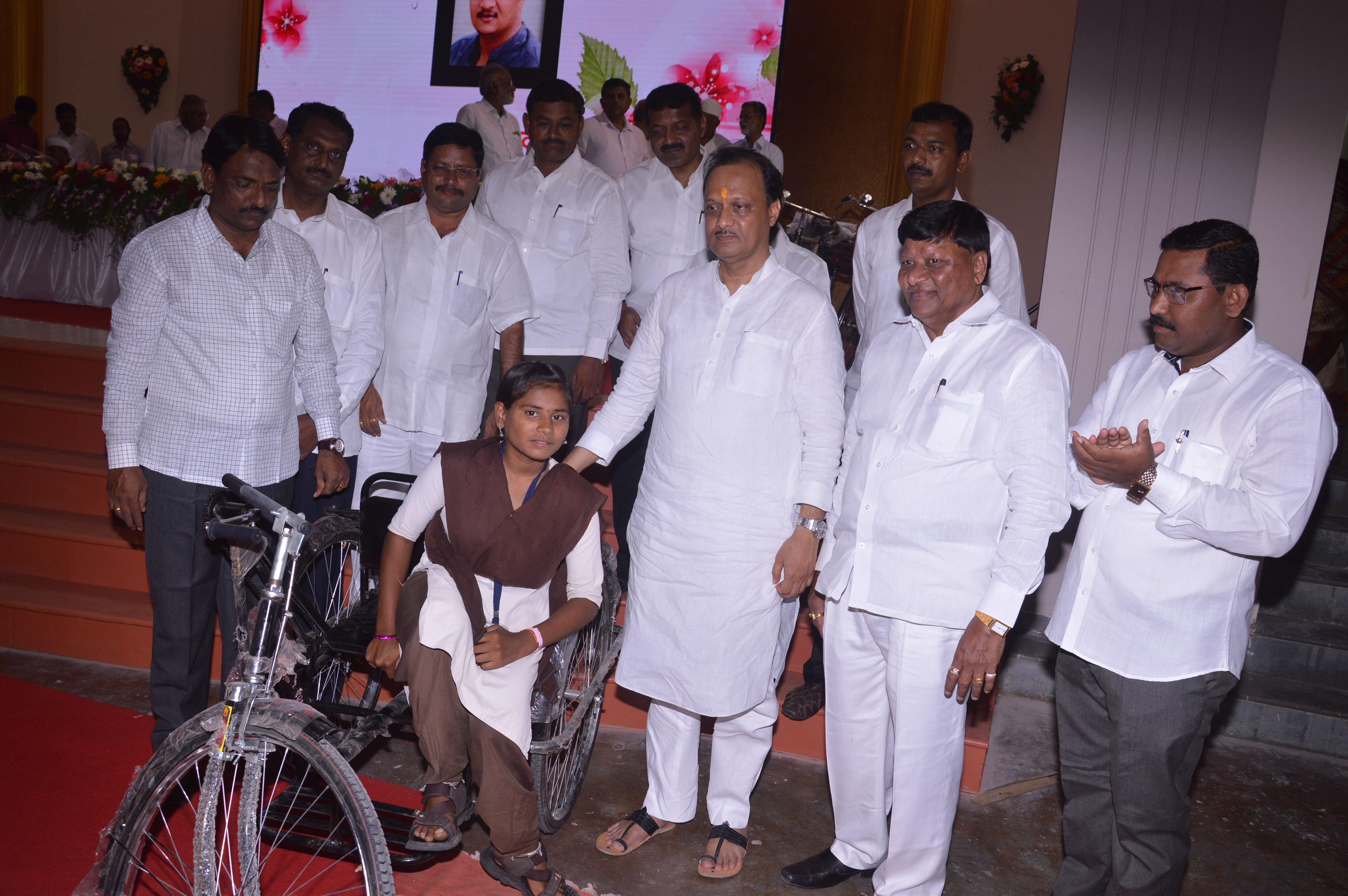 Distribution of educational material and tricycles to disabled students